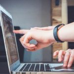 Modules page: Hand touching laptop screen